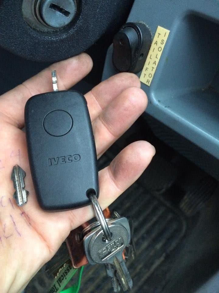Worn car key and spares held in a hand