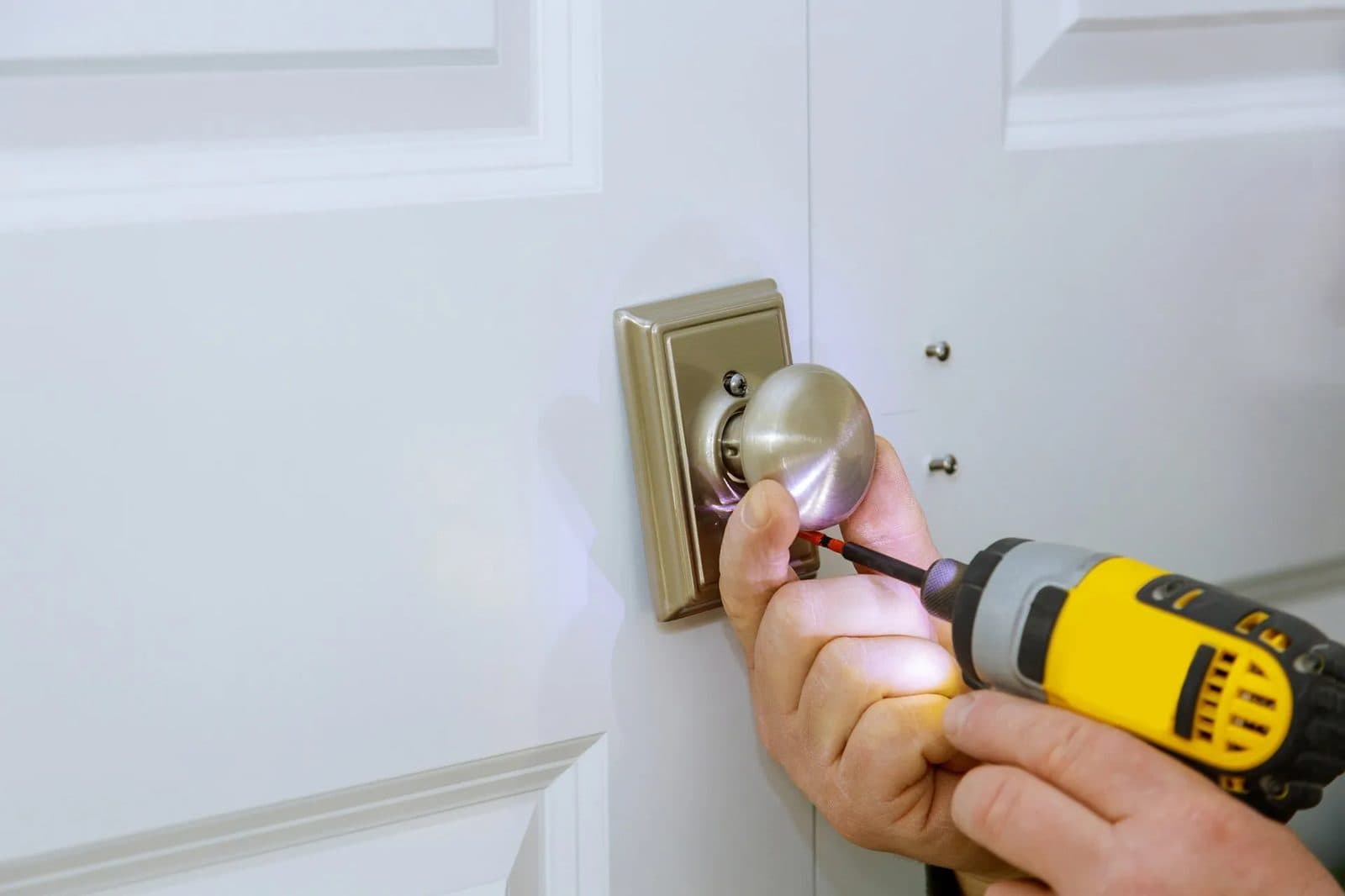 Fitting a new lock to a door with a drill