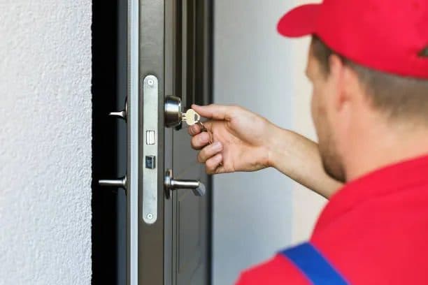 Locksmith working on a front door lock